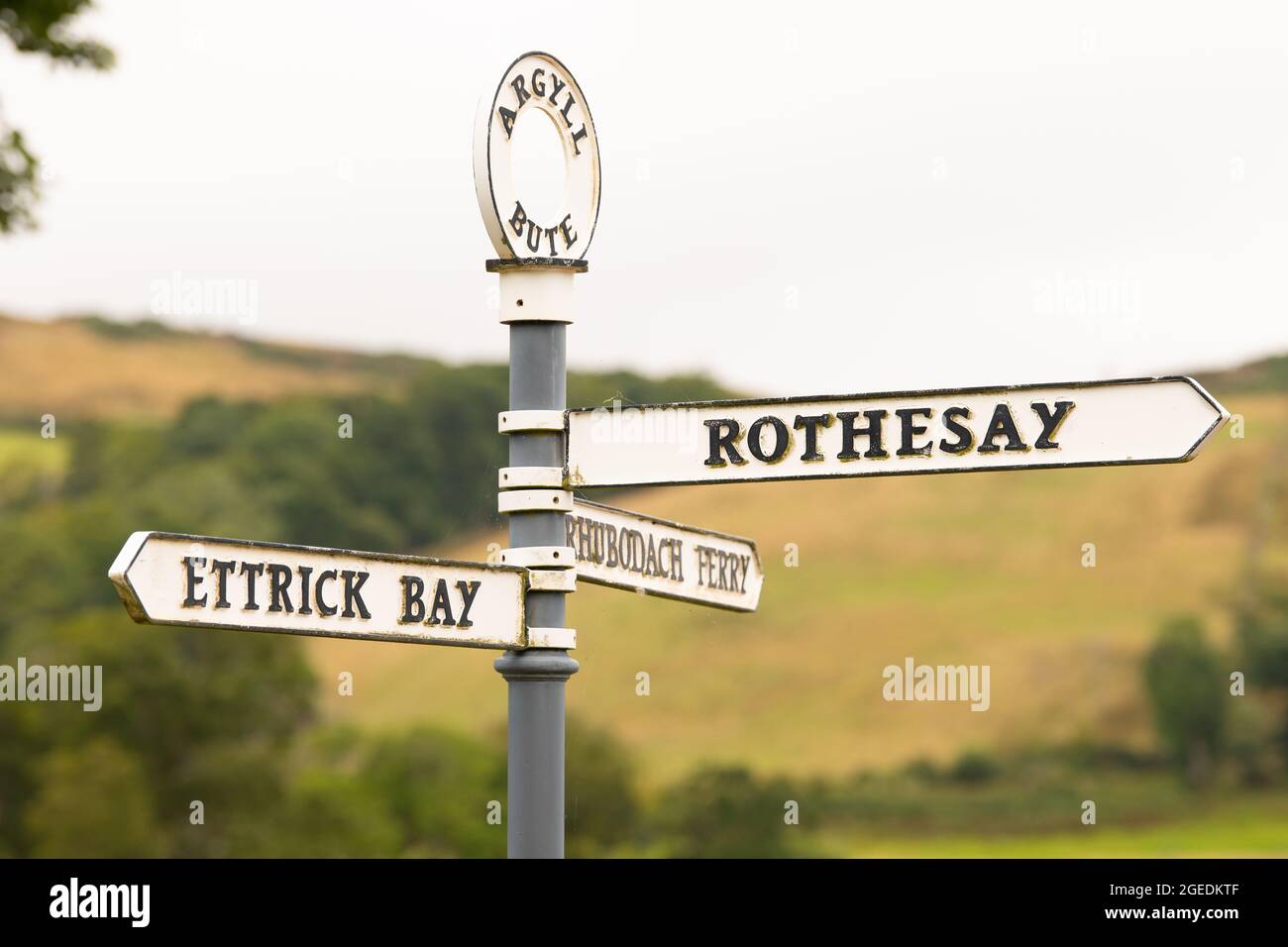 Isle of Bute road sign pointing to Rothesay, Rhubodach Ferry and Ettrick Bay, Argyll and Bute, Scotland, UK Stock Photo