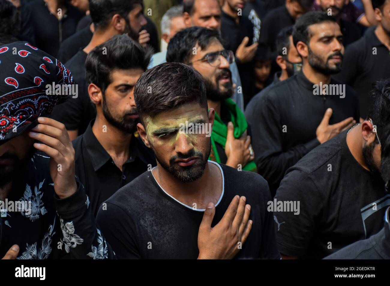 A Kashmiri Shiite Muslim takes part in a ritual religious procession ...