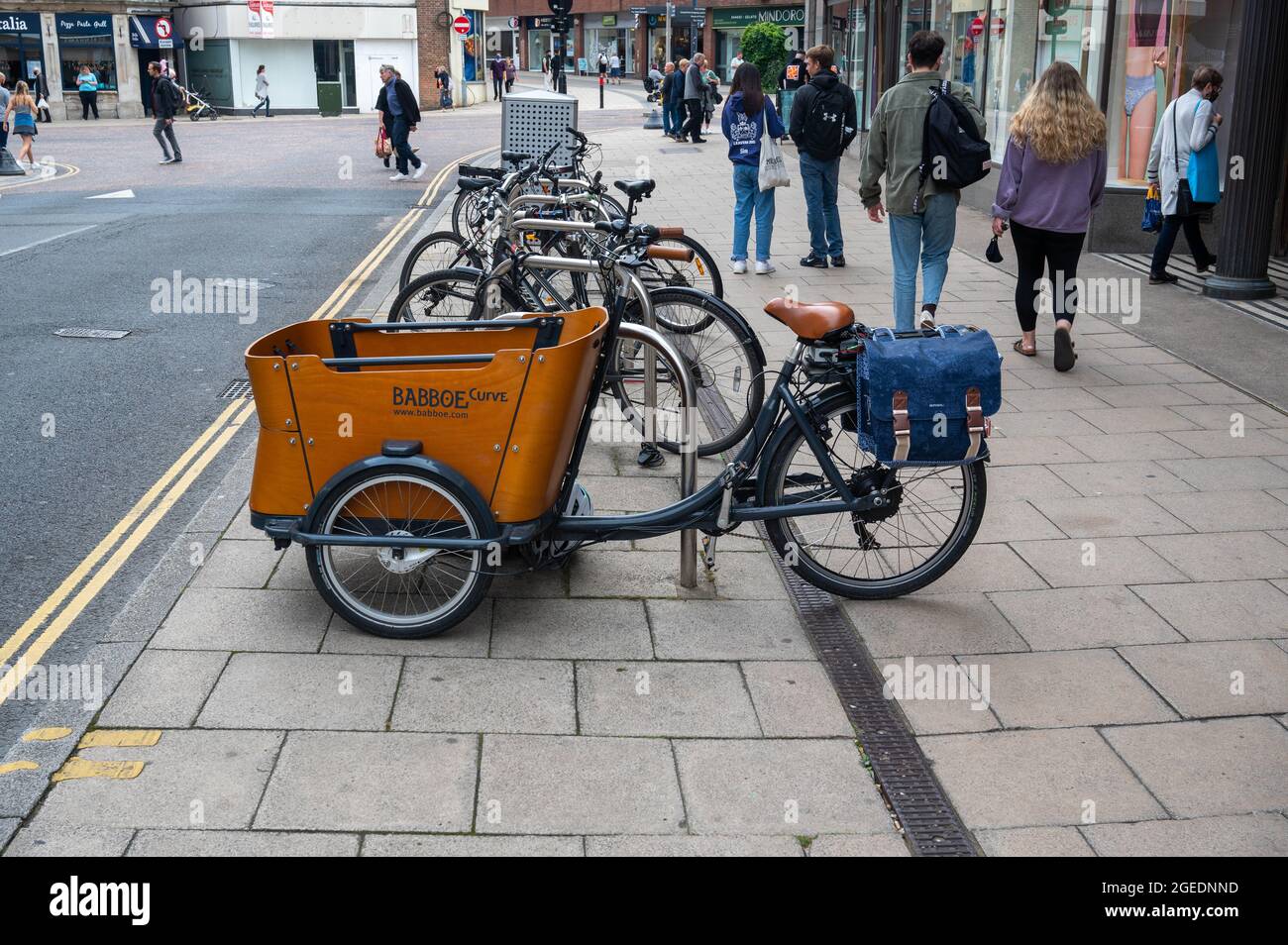 A Babboe curve  electric bike  parked in a cycle area outside  Marks and spencers on Rampant Horse Street Norwich Stock Photo