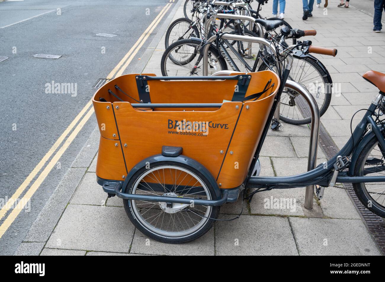 A Babboe curve  electric bike  parked in a cycle area outside  Marks and spencers on Rampant Horse Street Norwich Stock Photo