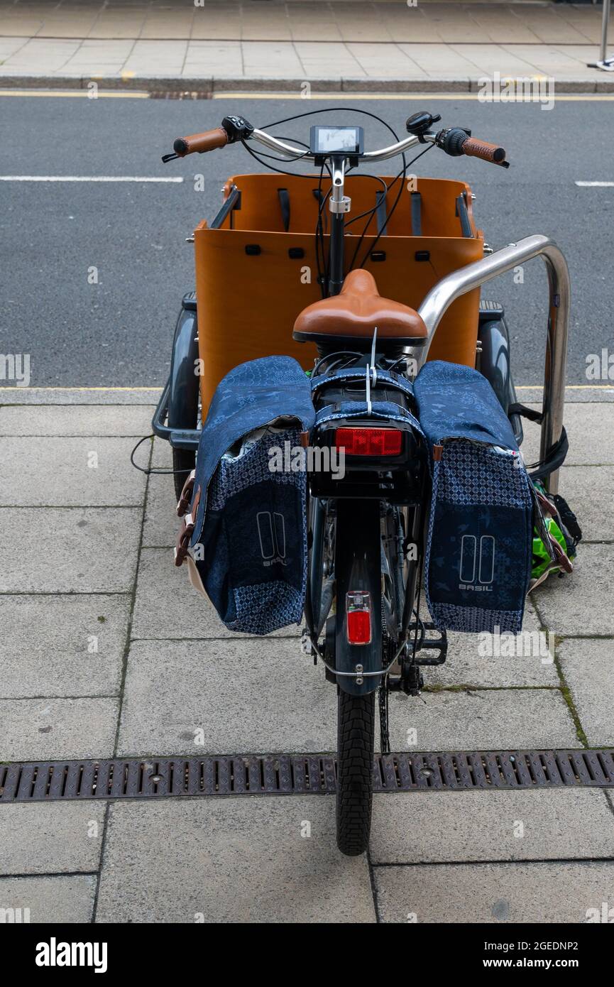 A Babboe curve  electric bike  parked in a cycle area outside  Marks and spencers on Rampant Horse Street Norwich Stock Photo