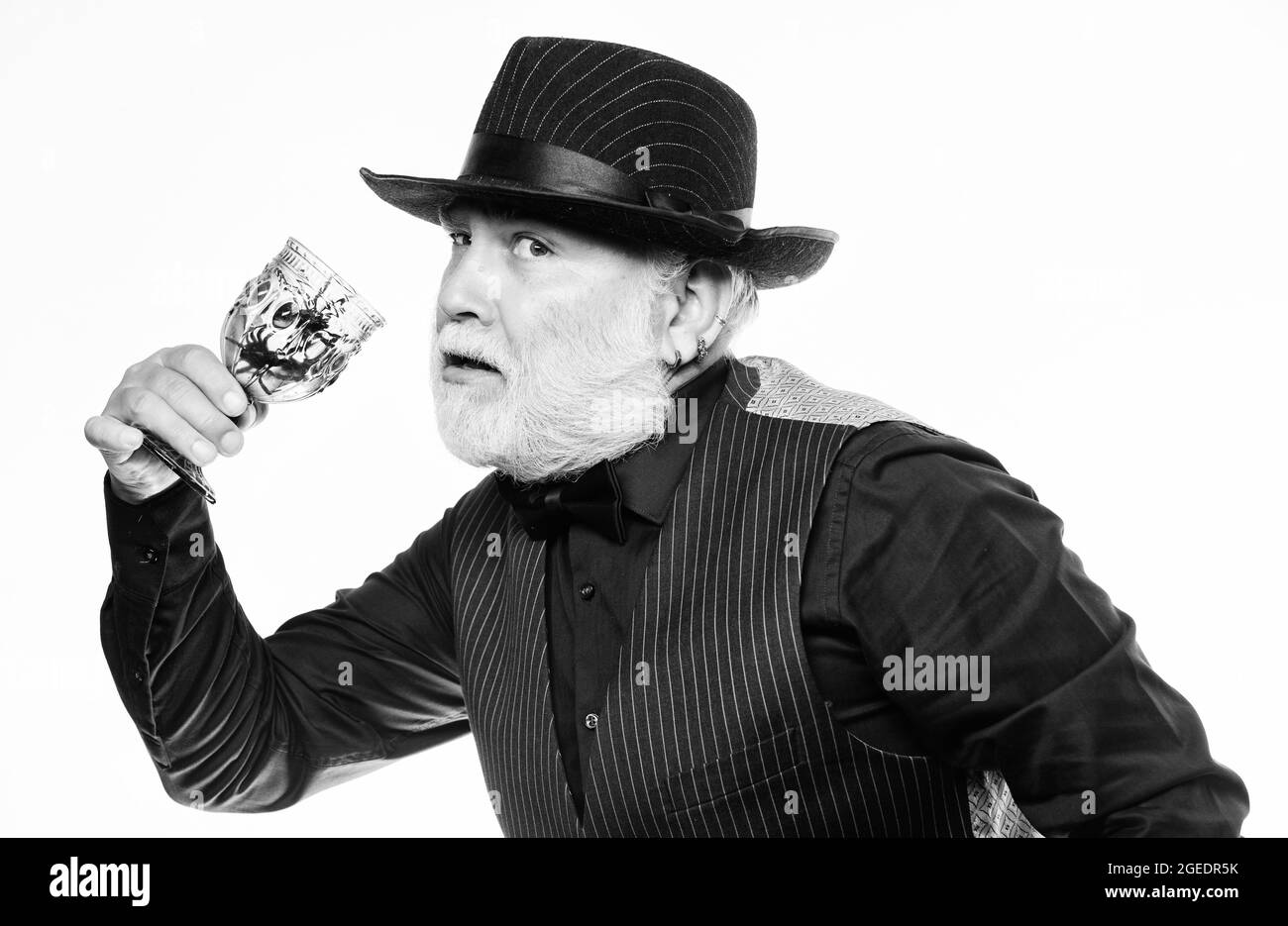 On Halloween night. evil wizard cooking magic potion with spider. mature man magician in witch hat. happy halloween. barman make cocktail for Stock Photo
