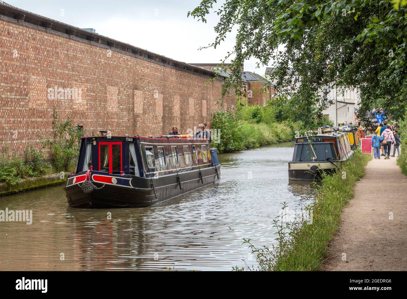 A couple take a relaxing boat ride along the Grand Union Canal in Royal
