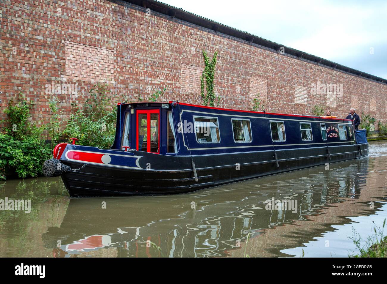 A couple take a relaxing boat ride along the Grand Union Canal in Royal