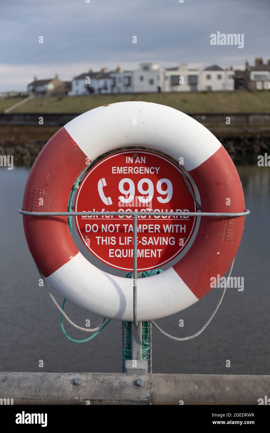 Red and white life saving ring at Seahouses Harbour, North Sunderland ...