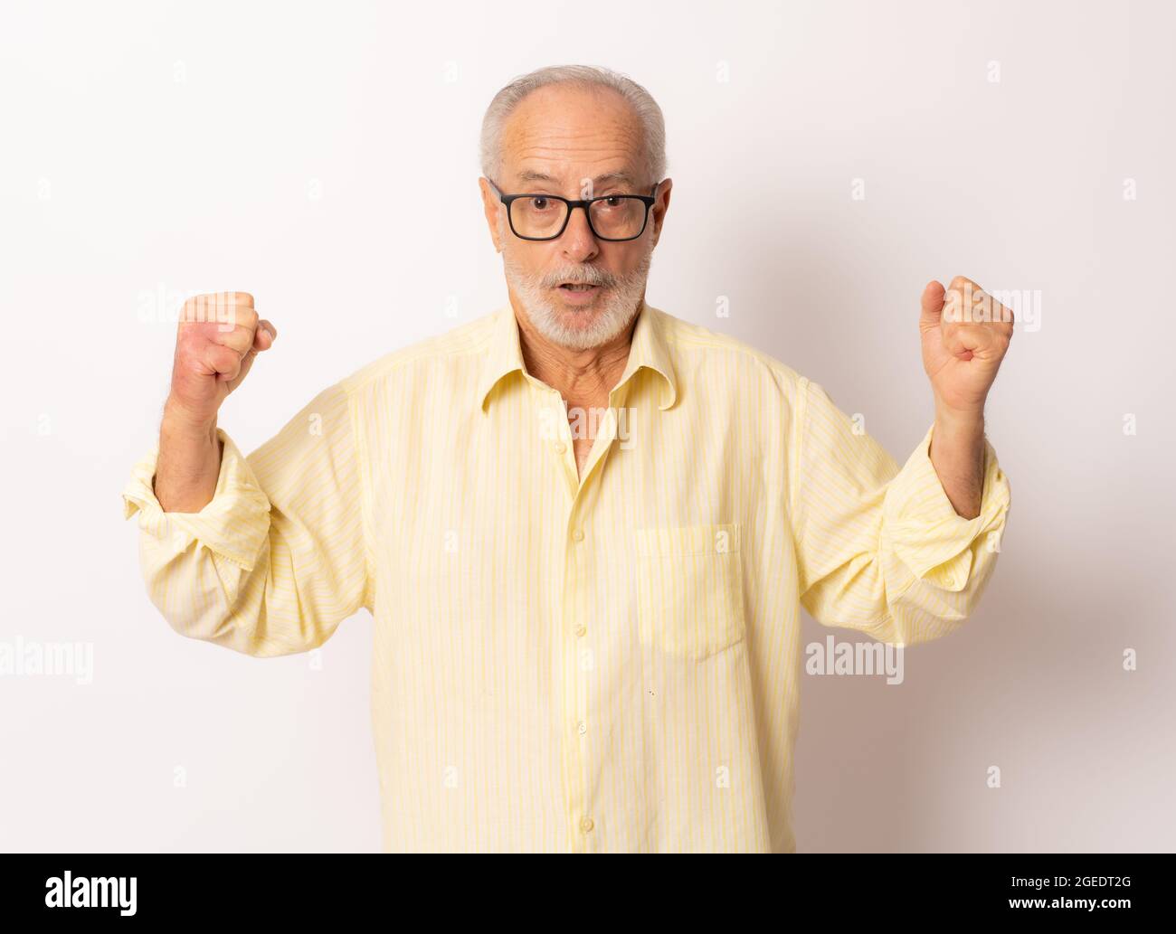 Senior man making the winner gesture over white background. Stock Photo