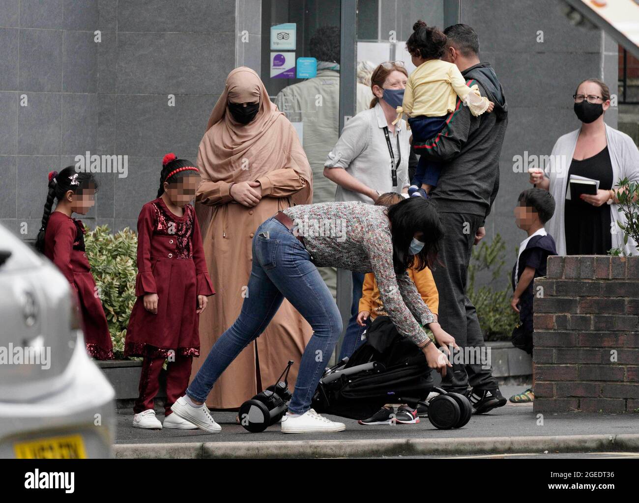 EDITORS NOTE Children's faces have been pixelated as the PA Picture Desk has been unable to gain the necessary permission to photograph a child under 16 on issues involving their welfare. People leave the Sheffield Metropolitan Hotel in Blonk Street, where a five year old boy, an Afghan refugee whose family recently fled the Taliban, died after he fell from a window on Wednesday. Picture date: Thursday August 19, 2021. Stock Photo