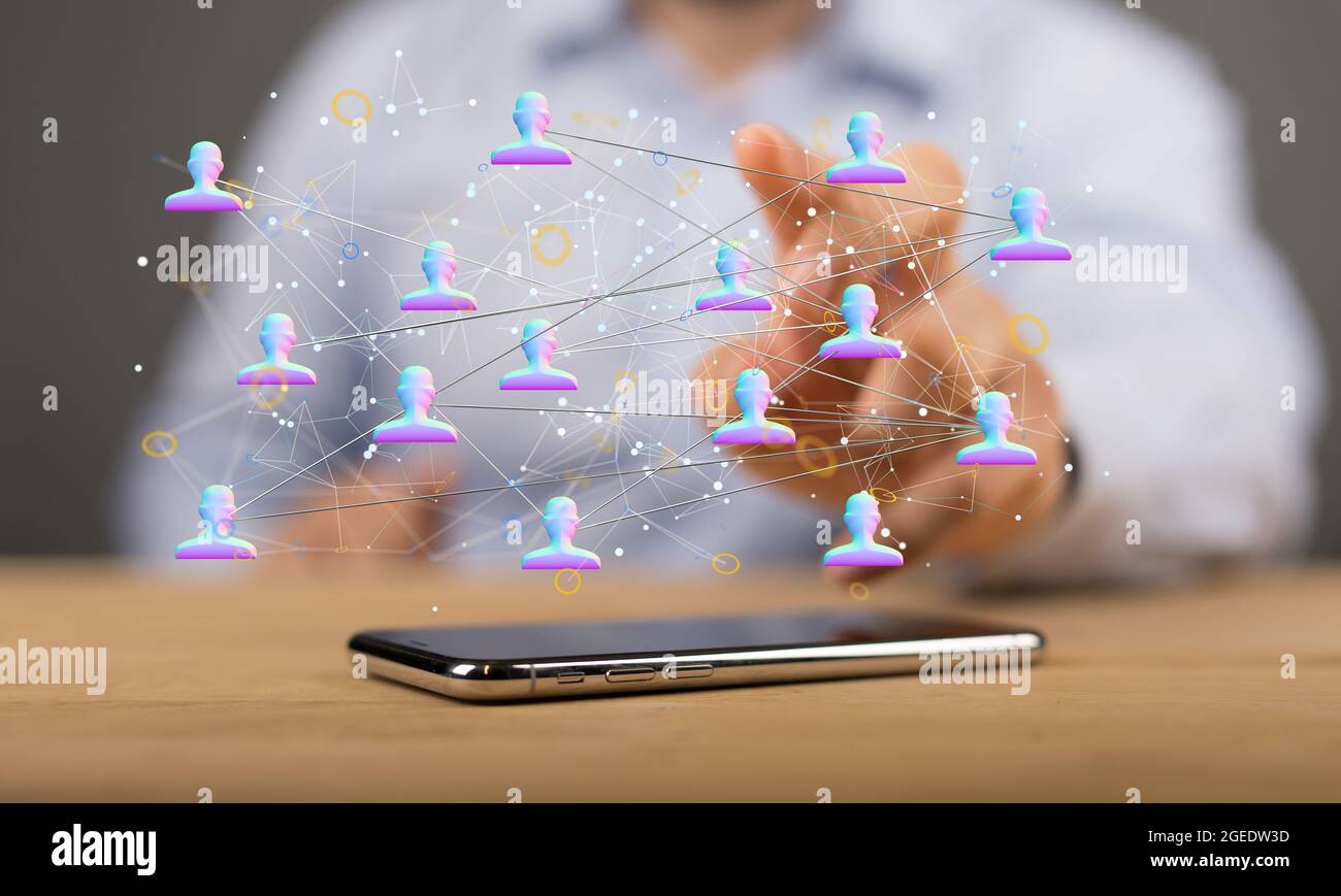 Person's hand touching 3D rendered people silhouettes in the network ...