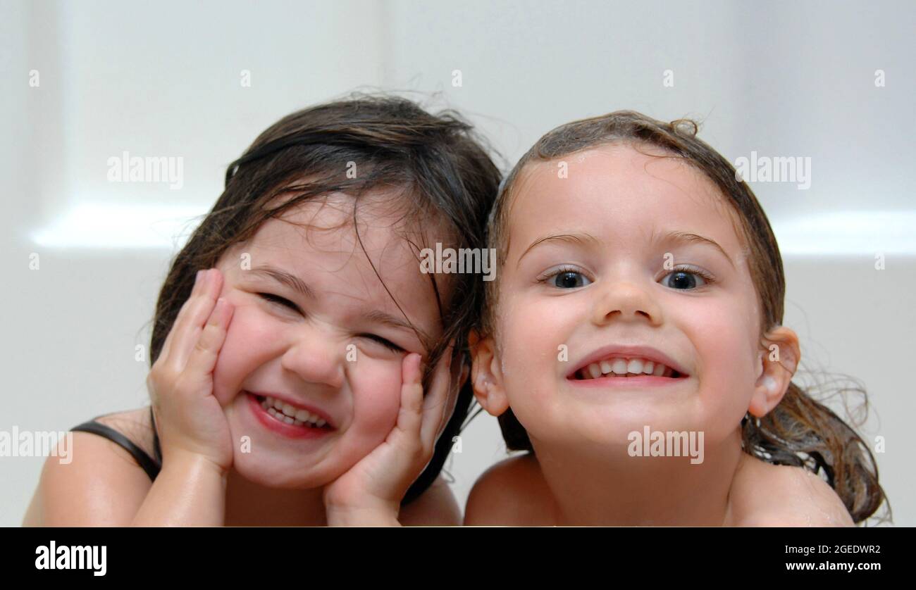 Two Girls With Wet Sudsy Hair Smile At The Camera These Sisters Look