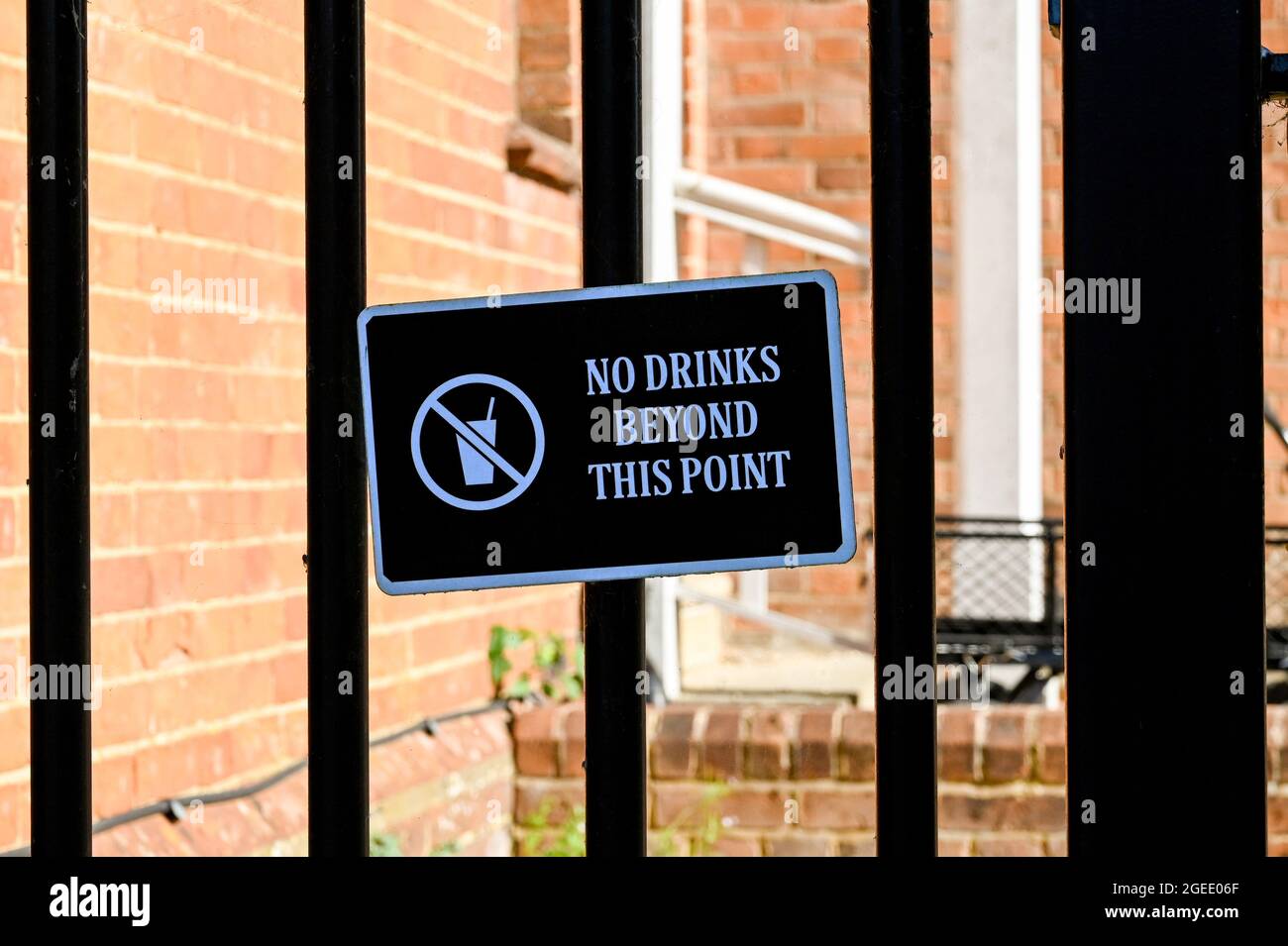 Sign warning customers not to take drinks past the gate. No people. Stock Photo