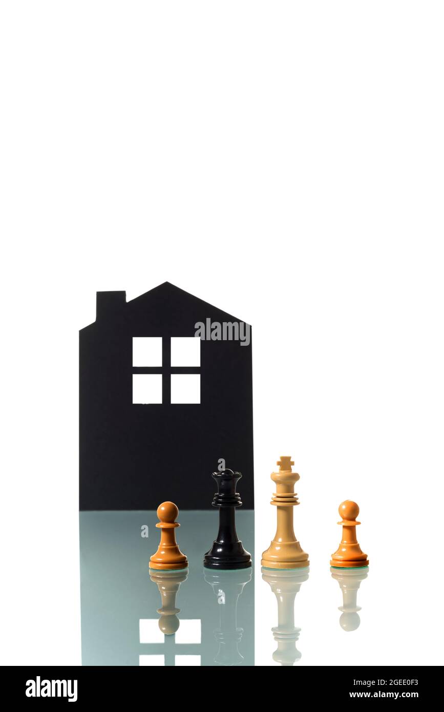Conceptual photograph of two chess pieces metaphorically representing an interracial heterosexual couple forming a family with two children; with the Stock Photo