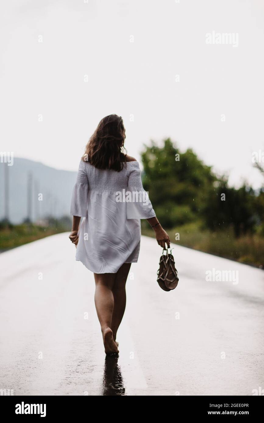 Woman walking barefoot street hi-res stock photography and images - Alamy