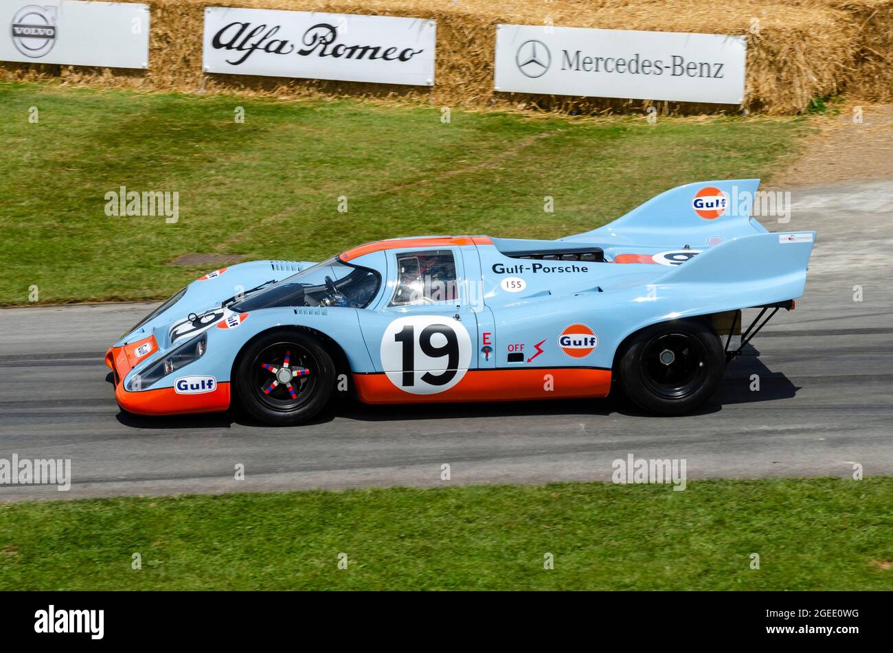 Porsche 917K in classic Gulf Oil colour scheme racing car driving up the hill climb track at the Goodwood Festival of speed motor racing event 2014 Stock Photo