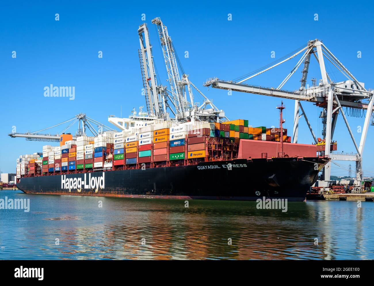 The Guayaquil Express container ship from Hapag-Lloyd shipping company being loaded by container gantry cranes in the port of Le Havre, France. Stock Photo