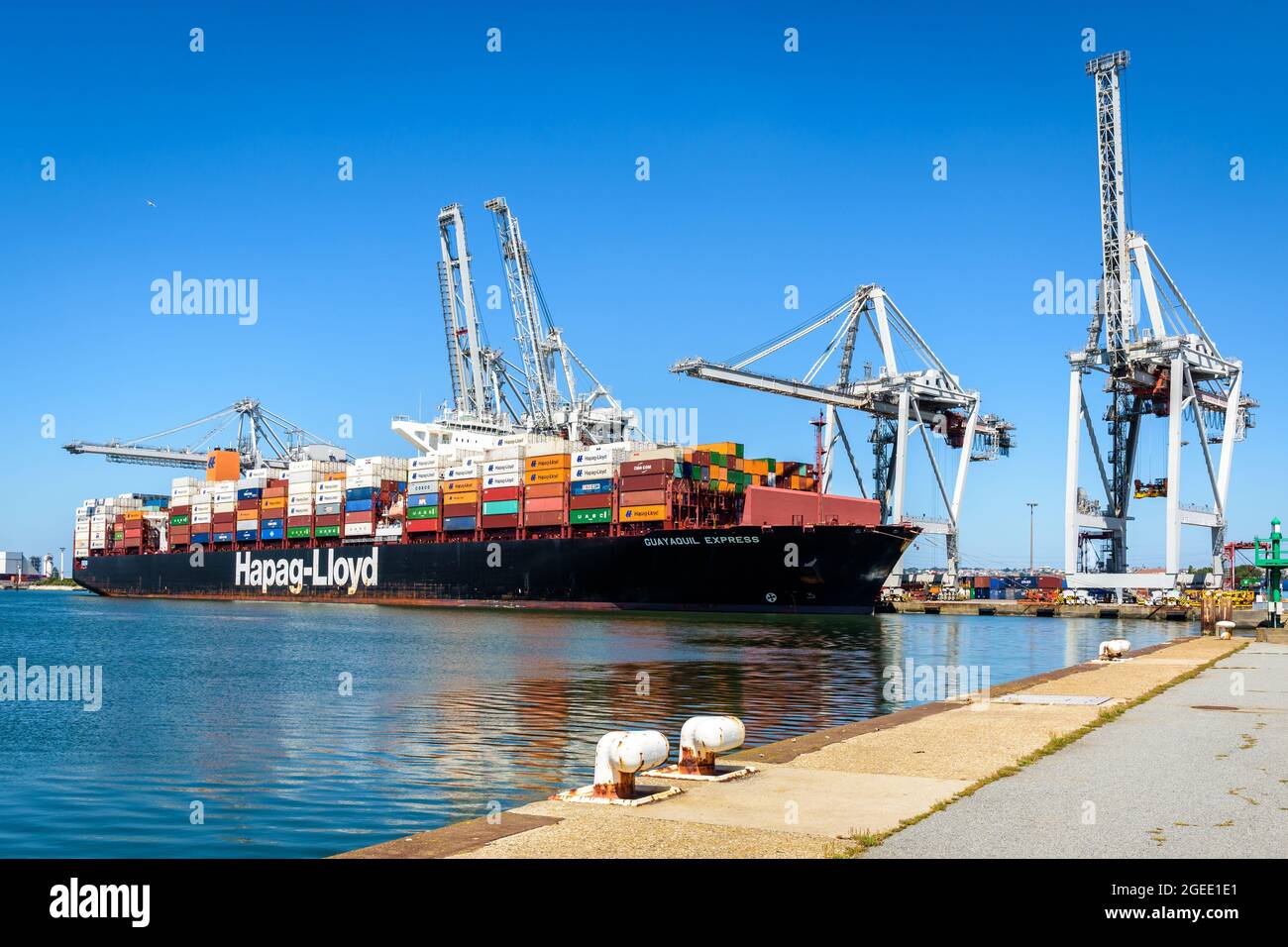 The Guayaquil Express container ship from Hapag-Lloyd shipping company being loaded by container gantry cranes in the port of Le Havre, France. Stock Photo