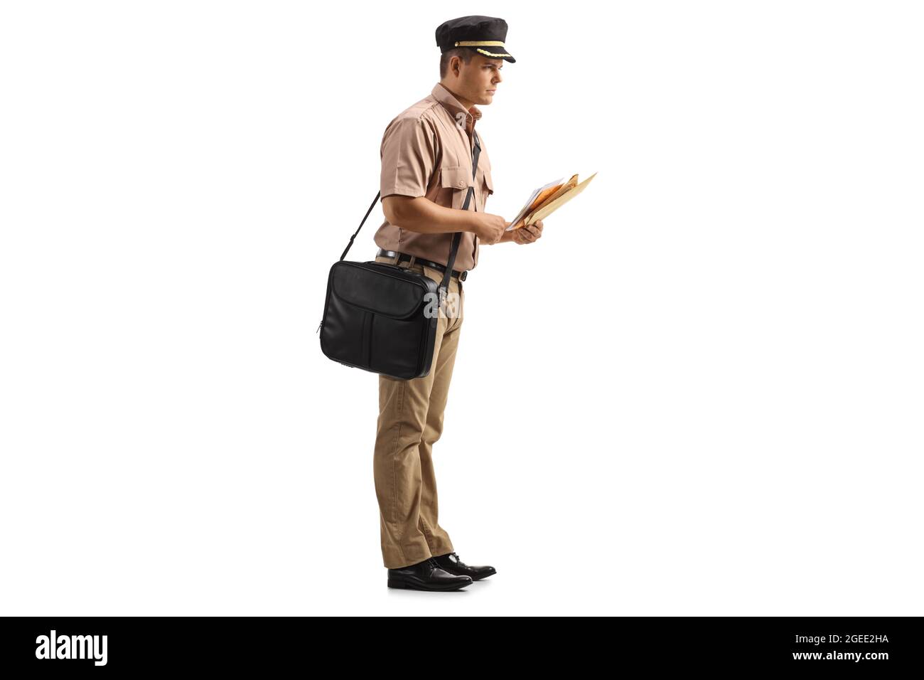 Full length profile shot of a mailman with a bag delivering letters
