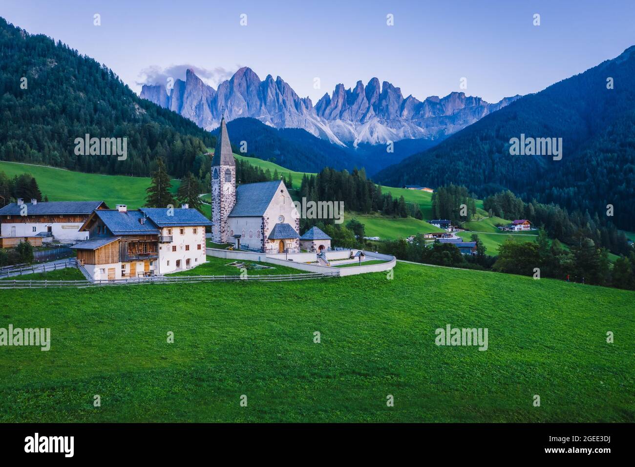 St Magdalena church in Val di Funes valley, Dolomites, Italy. Furchetta and Sass Rigais mountain peaks in background Stock Photo