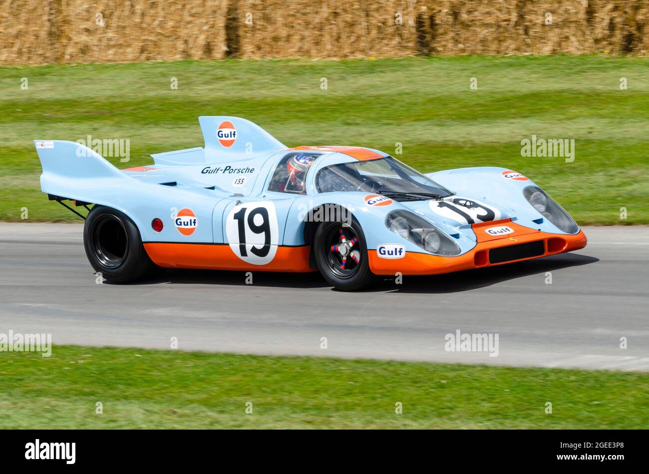 Porsche 917K racing car in classic Gulf Oils colour scheme driving up the hill climb track at the Goodwood Festival of Speed motor racing event 2014. Stock Photo