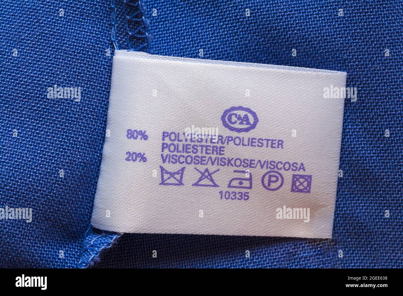 label in woman's blue jacket from C&A 80% polyester 20% viscose with washing care symbols Stock Photo