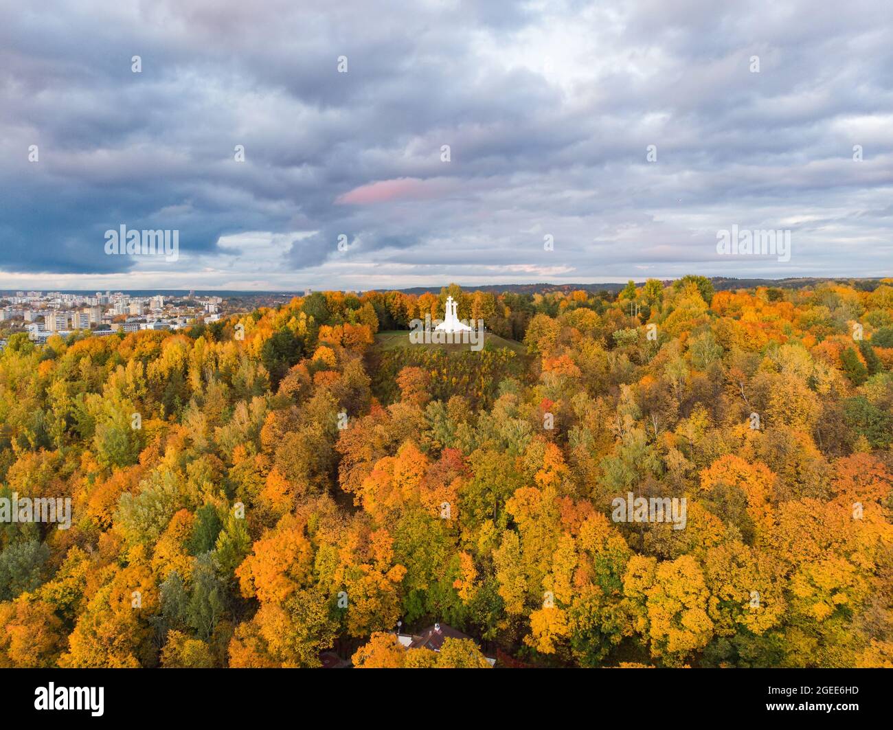 Aerial view of the Three Crosses monument overlooking Vilnius Old Town on sunset. Vilnius landscape from the Hill of Three Crosses, located in Kalnai Stock Photo