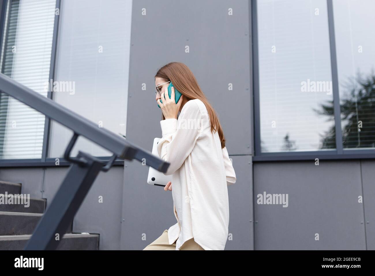 young stylish white woman talking on a smartphone Stock Photo