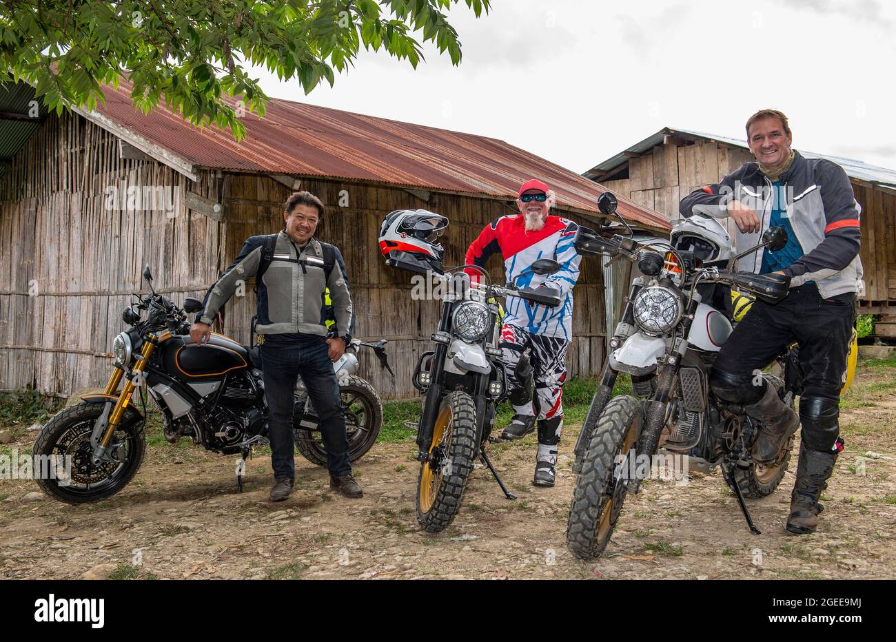 men stopping with their motorcycle's in Thai village Stock Photo