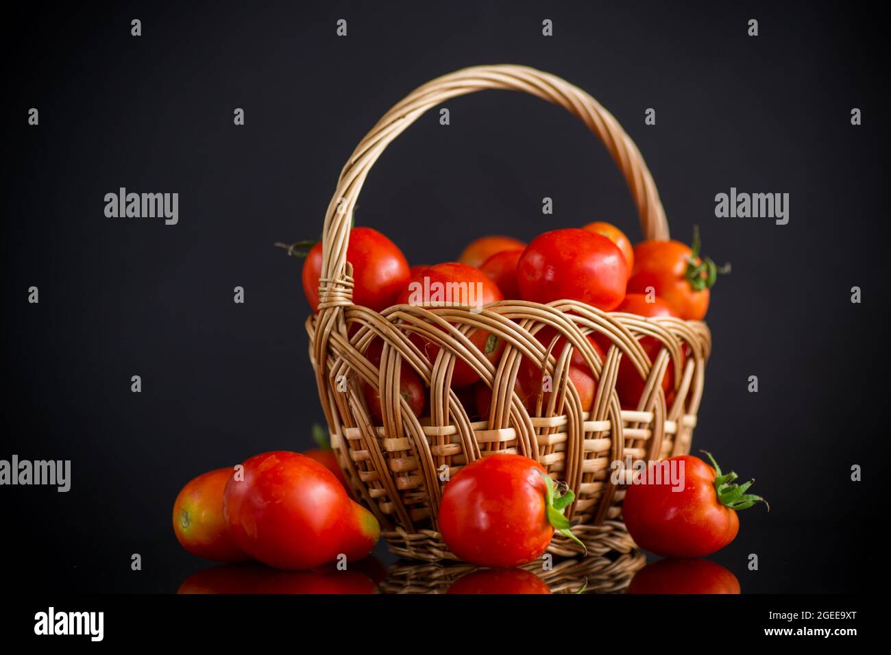 fresh ripe red tomatoes in basket isolated on black background Stock ...