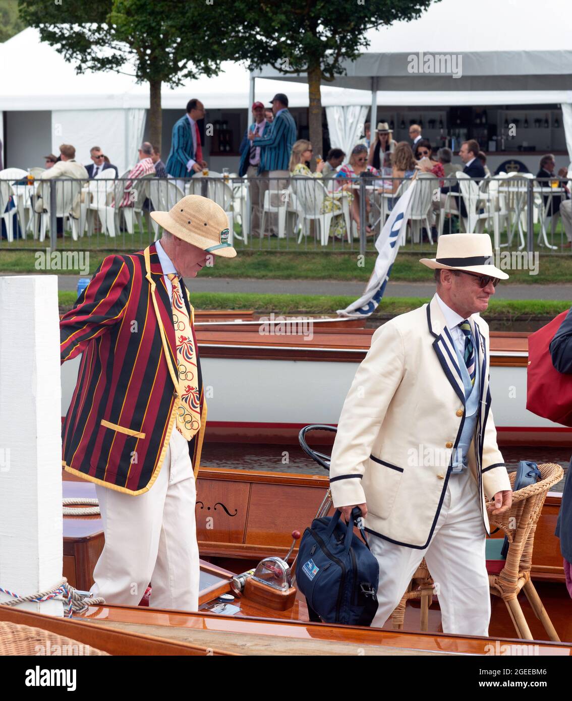 Two men in traditional rowing blazers stepping off an umpires boat at Henley Royal Regatta (2021), Henley-on-Thames, Oxfordshire, England Stock Photo