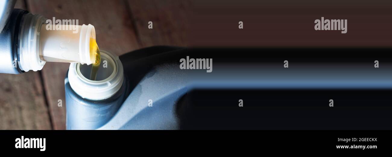 Panoramic banner motor pouring engine oil from plastic container