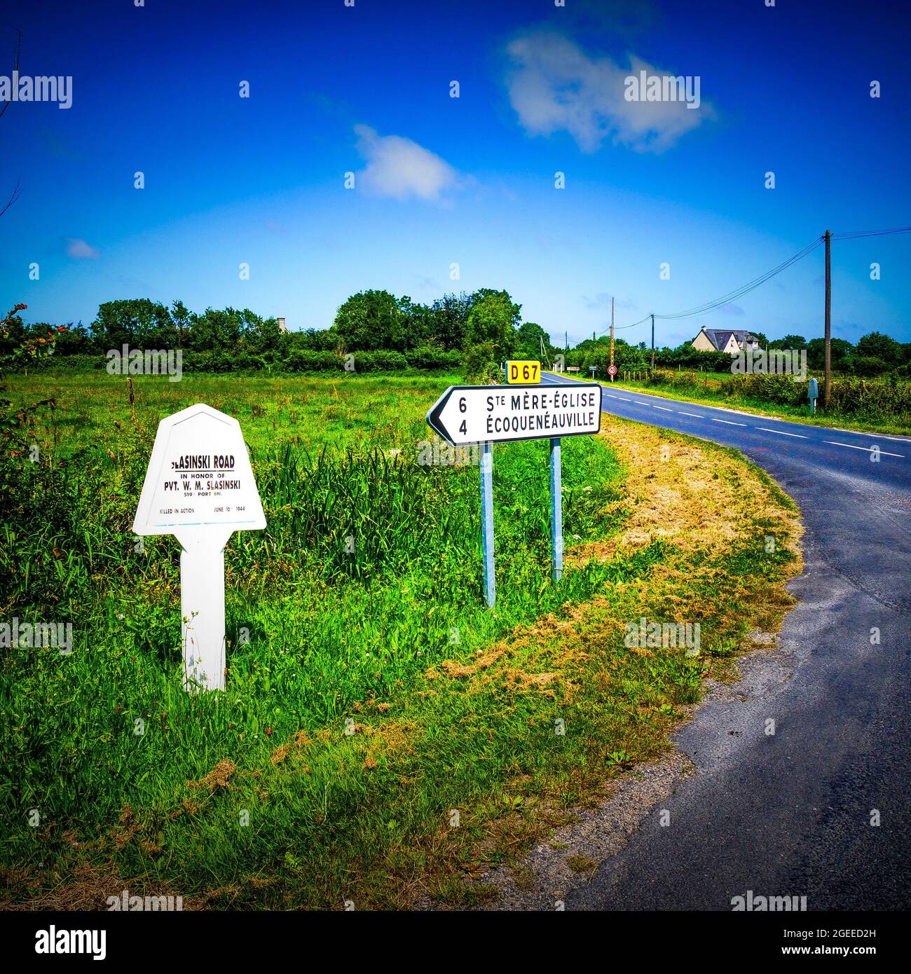 Road sign paying homage to american soldier, Audouville, Manche