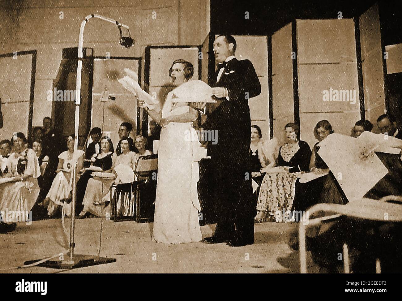 Circa 1947 - An operetta being performed in a the original BBC  (British Broadcasting Company / Corporation)   studios. London, UK.1927 saw the establishment of British Broadcasting Corporation  by Royal Charter with  Reith as its first Director-General.  John Logie Baird began experimenting  with television broadcasts on BBC frequencies in November 1929. Stock Photo
