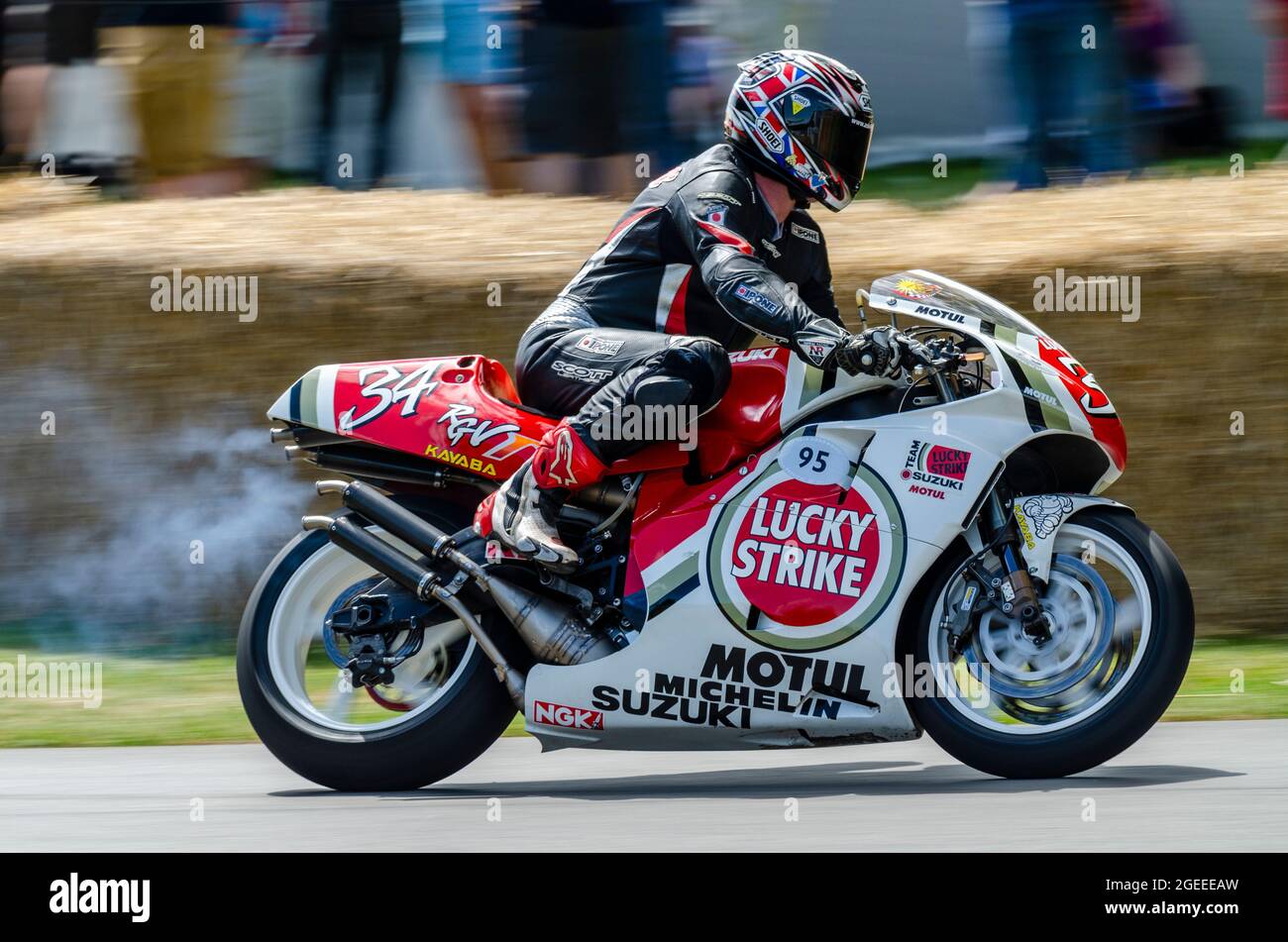 1995 Lucky Strike Suzuki RGV500 Grand Prix motorcycle racing up the hill climb track at the Goodwood Festival of Speed motor racing event 2014 Stock Photo