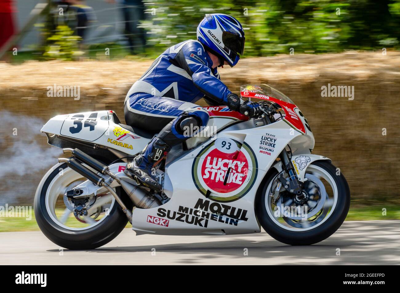 1993 Lucky Strike Suzuki RGV500 Grand Prix motorcycle racing up the hill climb track at the Goodwood Festival of Speed motor racing event 2014 Stock Photo