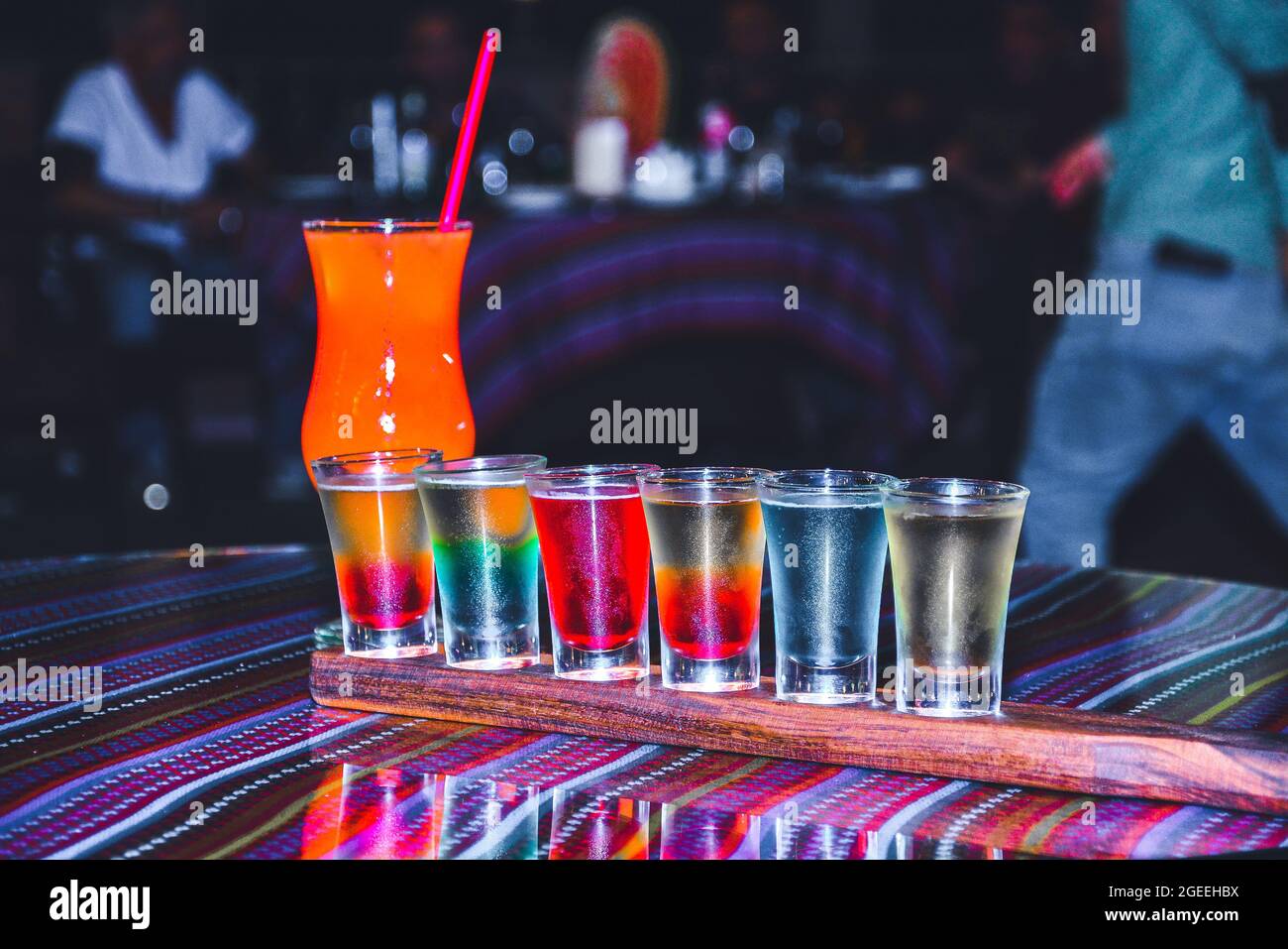 The bartender prepares cocktails. Multi-colored cocktail. Refreshing ...