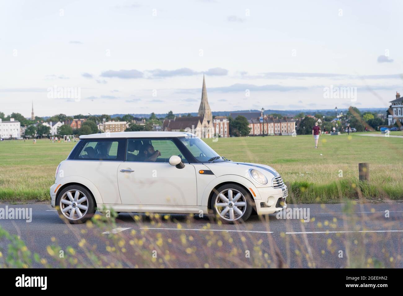 side view Mini cooper white on road A2 England Stock Photo - Alamy