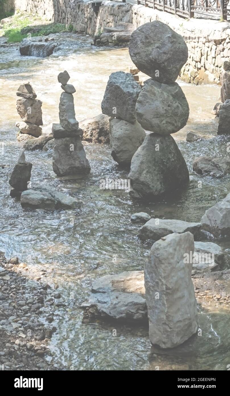Balancing rocks sculpture made of stones from the river in the background. Zen concept Stock Photo