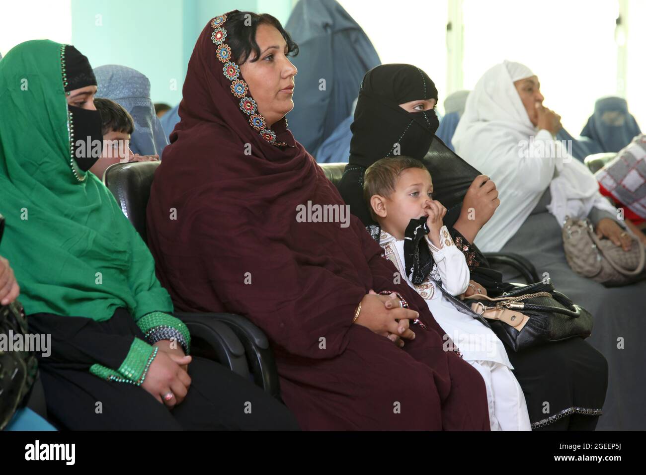 Local women listen to a speaker at an International Women's Day meeting at the Khost Provincial Headquarters in Khost city, Khost province, Afghanistan, March 9, 2013. The meeting was one of the largest gatherings of women to ever occur in Khost province. They discussed a woman's strength and responsibility in her household as well as higher education for all women and girls. (U.S. Army photo by Sgt. Kimberly Trumbull / Released) Stock Photo