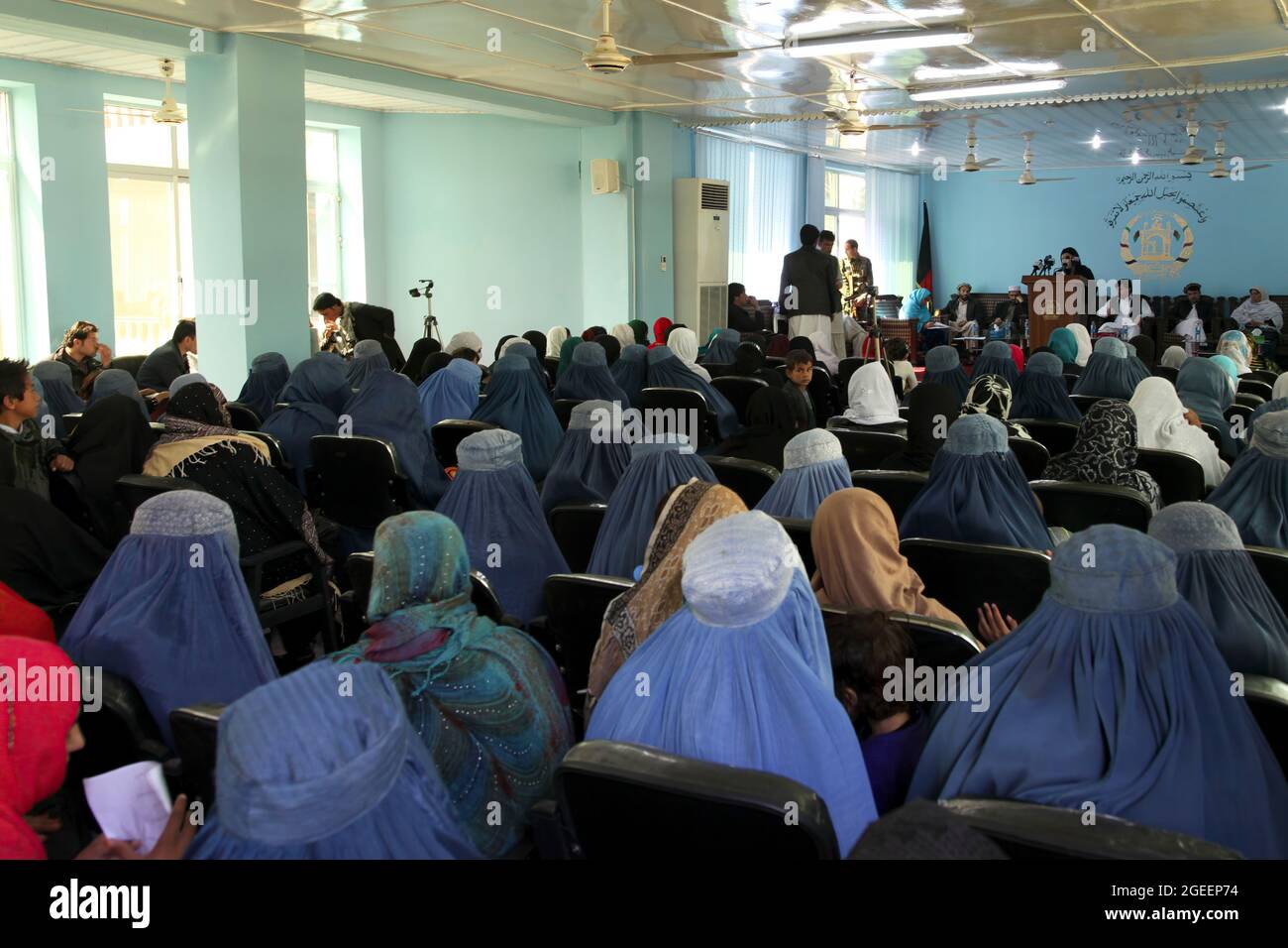 Local women listen to a speaker at an International Women's Day meeting at the Khost Provincial Headquarters in Khost city, Khost province, Afghanistan, March 9, 2013. The meeting was one of the largest gatherings of women to ever occur in Khost province. They discussed a woman's strength and responsibility in her household as well as higher education for all women and girls. (U.S. Army photo by Sgt. Kimberly Trumbull / Released) Stock Photo