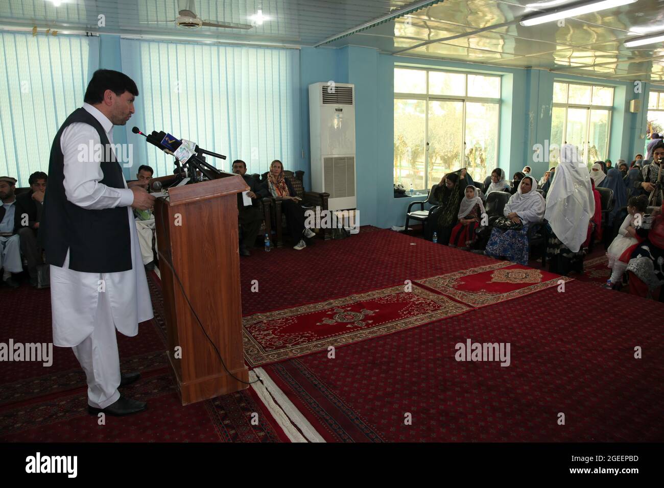 Khost Provincial Governor Abdul Jabar Naeemi offers the support of his office for issues concerning women's rights during a meeting for International Women's Day at the Khost Provincial Headquarters in Khost city, Khost province, Afghanistan, March 9, 2013. The meeting was one of the largest gatherings of women to ever occur in Khost province. They discussed a woman's strength and responsibility in her household as well as higher education for all women and girls. (U.S. Army photo by Sgt. Kimberly Trumbull / Released) Stock Photo