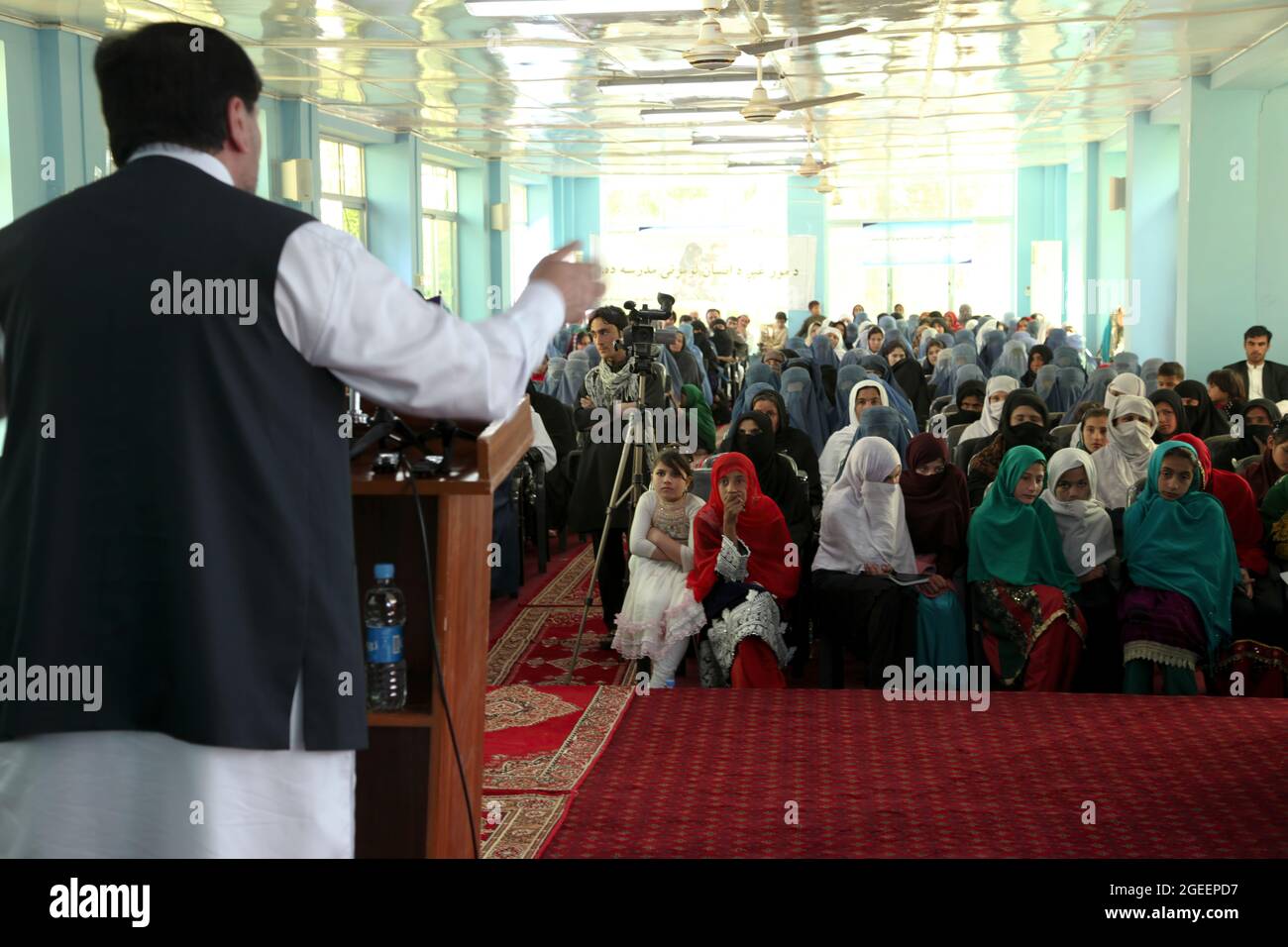 Khost Provincial Governor Abdul Jabar Naeemi offers the support of his office for issues concerning women's rights during a meeting for International Women's Day at the Khost Provincial Headquarters in Khost city, Khost province, Afghanistan, March 9, 2013. The meeting was one of the largest gatherings of women to ever occur in Khost province. They discussed a woman's strength and responsibility in her household as well as higher education for all women and girls. (U.S. Army photo by Sgt. Kimberly Trumbull / Released) Stock Photo