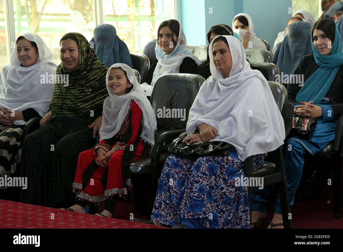 Local women listen to a speaker at an International Women's Day meeting at the Khost Provincial Headquarters in Khost city, Khost province, Afghanistan, March 9, 2013. The meeting was one of the largest gatherings of women to ever occur in Khost province. They discussed a woman's strength and responsibility in her household as well as higher education for all women and girls. (U.S. Army photo by Sgt. Kimberly Trumbull / Released) Stock Photo