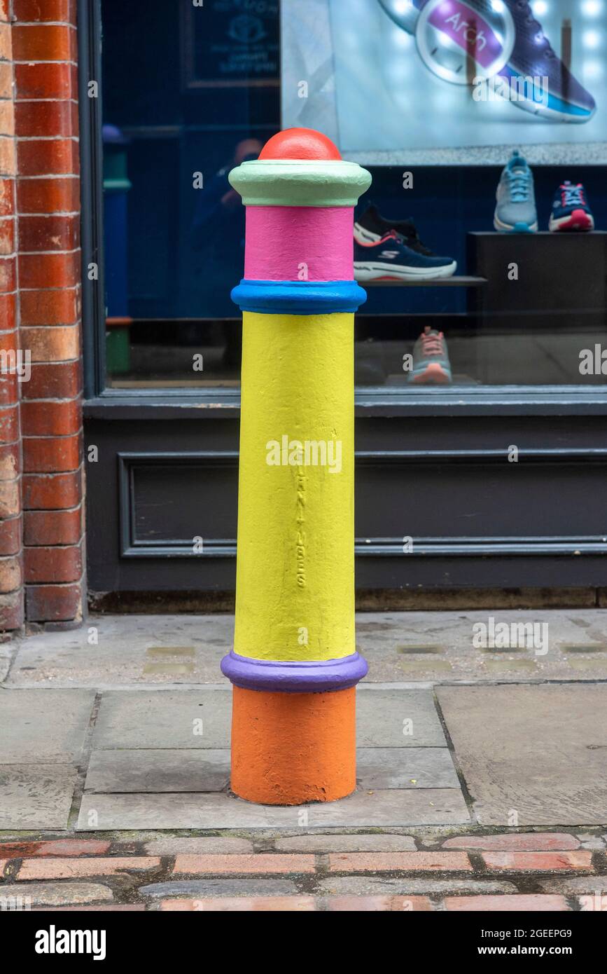 A hand painted Bollard in Floral Street, Covent Garden part of an art  installation “Nothing Can Separate Us” by London-born artist Lakwena. Flags  on bustling King Street and Henrietta Street emblazoned with