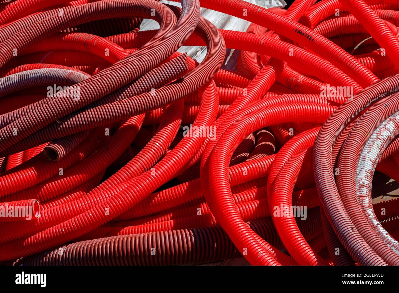 red corrugated PVC pipes for cable lay on the construction site Stock ...