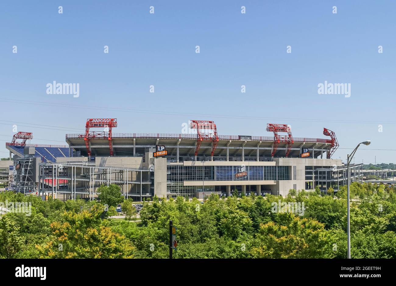 Nashville, TN, USA - May 19, 2007: Downtown. Giant LP Field Stadium, Nissan since 2015, where NFL Titans play under blue sky with green foliage in fro Stock Photo