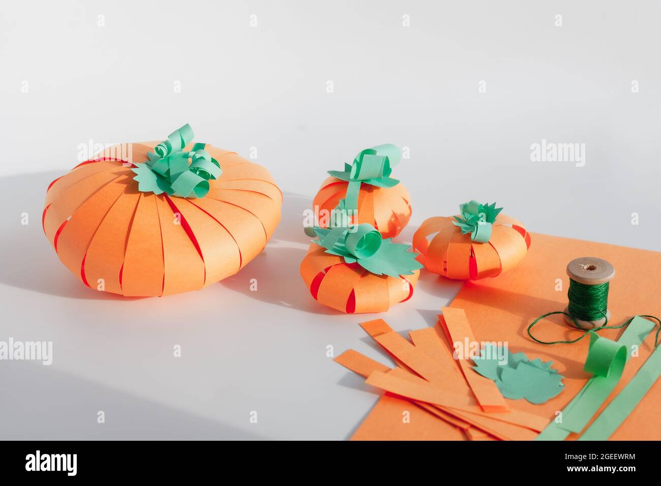 Several paper pumpkins hand made from strips of colored paper diy