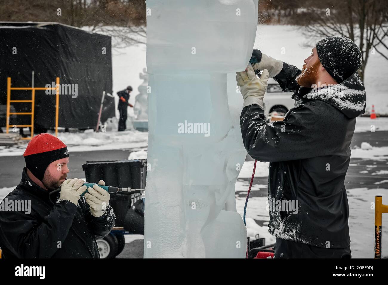 Two professional ice carvers sculpting block of ice Stock Photo Alamy