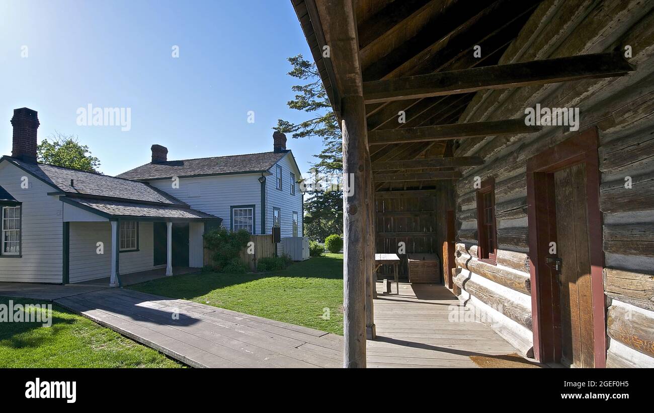 Wooden log cabin front porch and the building exterior of a historic house Stock Photo