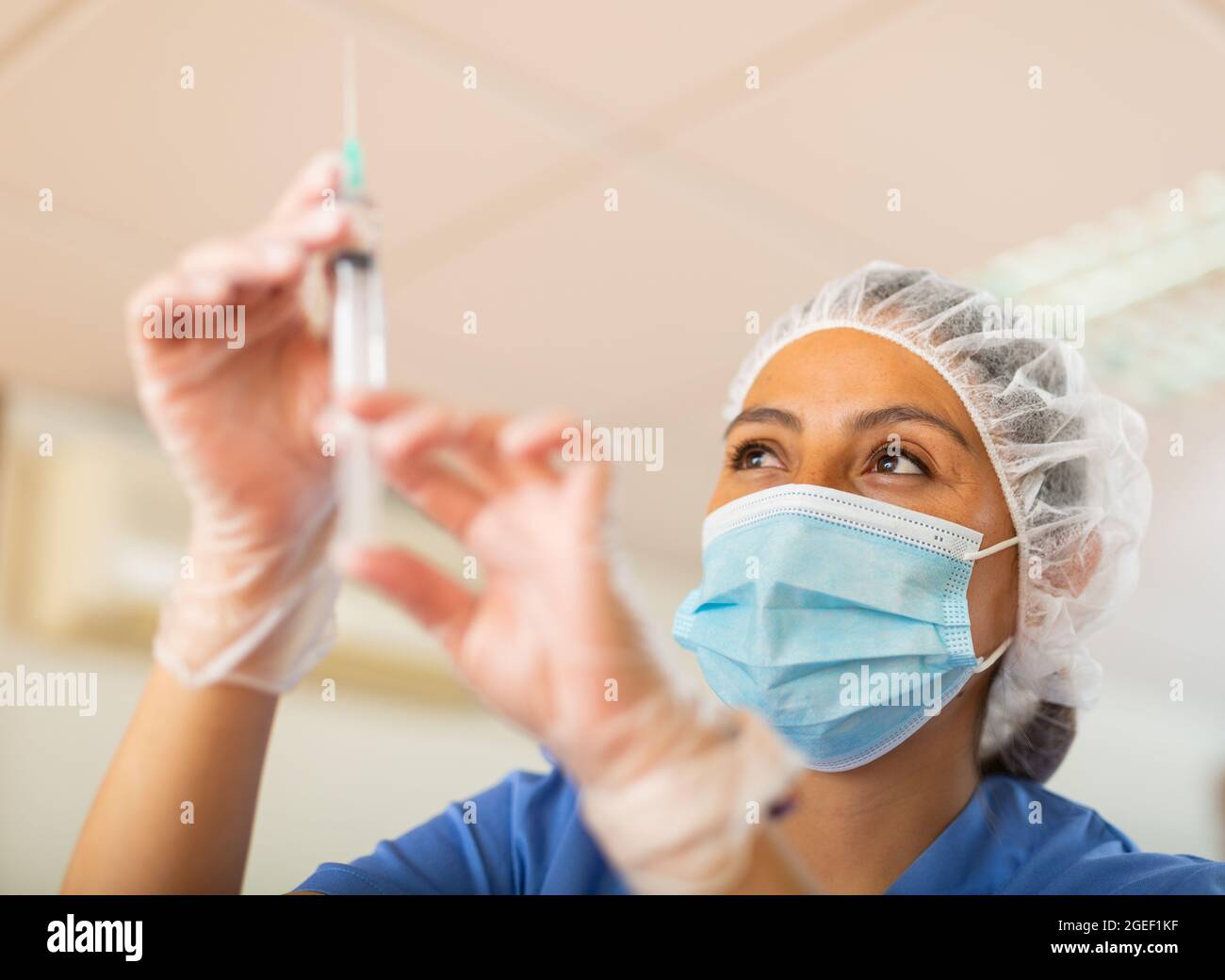 Young woman doctor assistant preparing syringe for injection Stock ...
