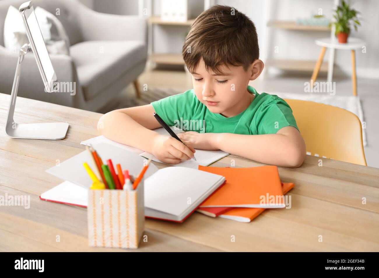 Little boy studying online at home Stock Photo
