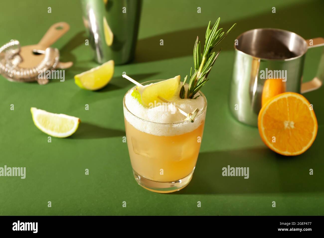 Glass of tasty whiskey sour cocktail on color background ...